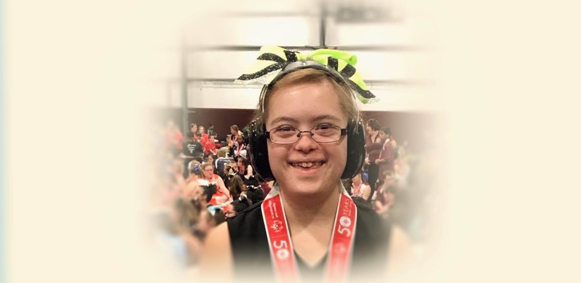 Teen smiling at the camera while wearing headphones