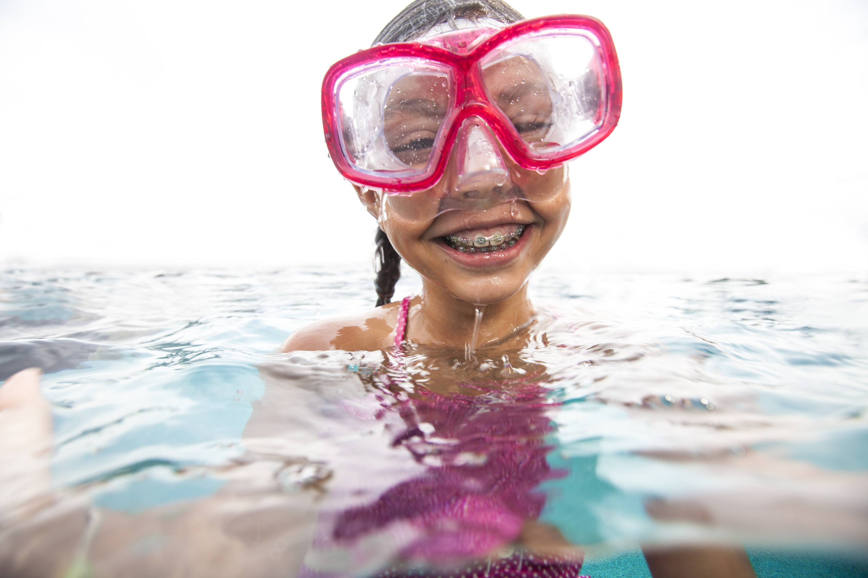 Young girl, snorkeling, goggles, beach, Caudill & McNeight Orthodontics, how to avoid stained teeth after braces or Invisalign