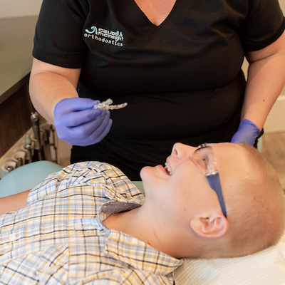 Boy getting clear retainer in exam chair