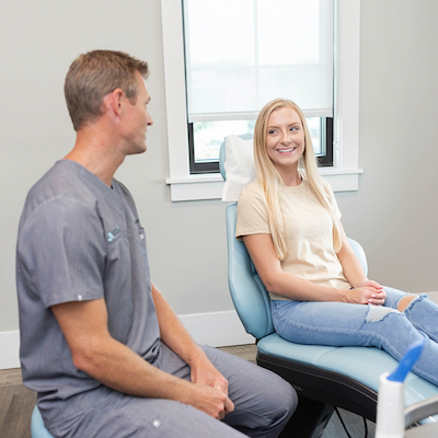 Teen patient sittingin consultation room with Dr. Caudill